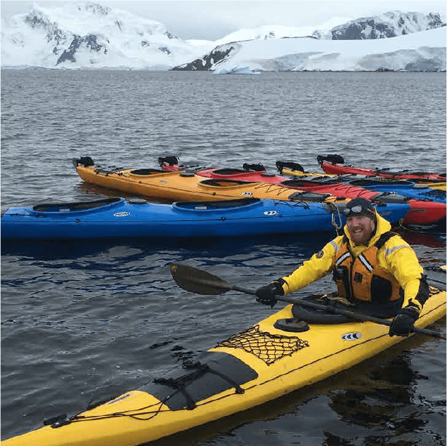 Thorkelson in a yellow ocean kayak in the arctic - Twin Tracks Expeditions Website Strategy and Design by Lydia Kitts of Turnquist House